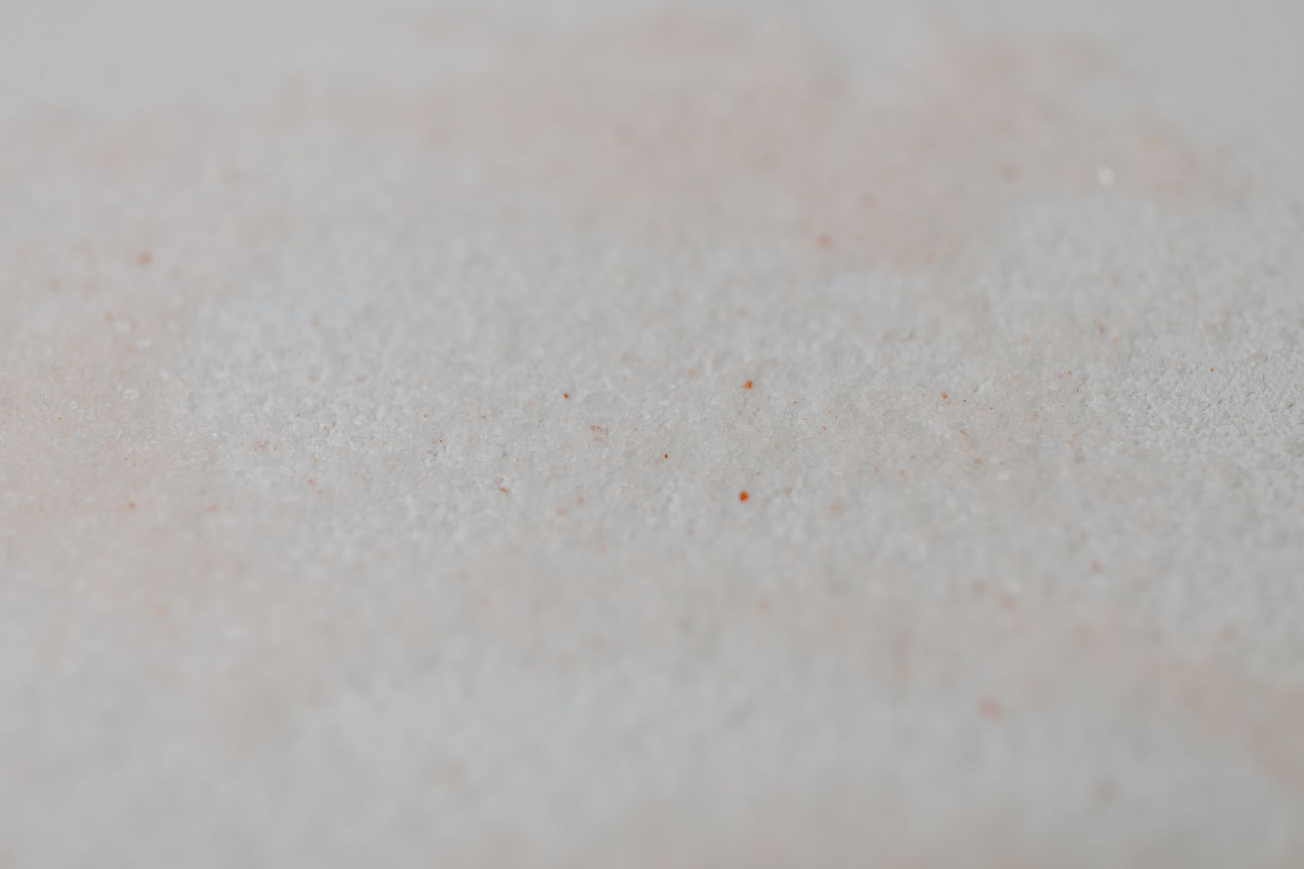 Detailed shot of a granular white texture, perfect for backgrounds.